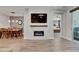 Modern living space with an electric fireplace, adjacent dining area, and a glimpse into a bedroom at 12957 Satin Lily Dr, Riverview, FL 33579