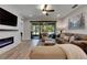 Comfortable living room with fireplace, ceiling fan, and sliding doors leading to an outdoor space at 12957 Satin Lily Dr, Riverview, FL 33579