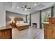 Bright main bedroom features tray ceiling, ceiling fan, and wood-look floors at 12957 Satin Lily Dr, Riverview, FL 33579