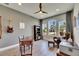 Home office with a ceiling fan, built in bookcase and windows offering a view of the neighborhood at 12957 Satin Lily Dr, Riverview, FL 33579
