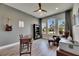 Home office featuring bright windows, wood desk, comfortable armchair, and neutral decor for a professional feel at 12957 Satin Lily Dr, Riverview, FL 33579