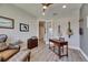 Home office with hardwood style floors, neutral paint, bright windows, and decorative guitars at 12957 Satin Lily Dr, Riverview, FL 33579