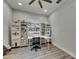Bright studio features a desk with storage and shelves filled with crafting supplies and decor at 12957 Satin Lily Dr, Riverview, FL 33579