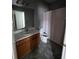 Functional bathroom featuring a vanity, toilet, and shower with a curtain at 13157 Kings Crossing Dr, Gibsonton, FL 33534