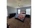 Spacious bedroom suite features two large windows, ceiling fan, neutral colors and carpet flooring at 13157 Kings Crossing Dr, Gibsonton, FL 33534