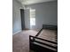 Bedroom with neutral walls, carpet floors, natural light, and closet offers comfort and functionality at 13157 Kings Crossing Dr, Gibsonton, FL 33534