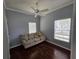 Cozy bedroom with hardwood floors, neutral wall color, and a comfy couch with pillows at 13157 Kings Crossing Dr, Gibsonton, FL 33534
