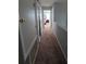 Upper level hallway with carpet floors leads to several bedrooms and closets at 13157 Kings Crossing Dr, Gibsonton, FL 33534
