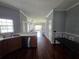 Kitchen area flows into dining space, featuring hardwood floors and stainless steel dishwasher at 13157 Kings Crossing Dr, Gibsonton, FL 33534