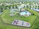 Aerial view of the community amenities, including a pool, playground, picnic area, and sports courts at 13803 Chalk Hill Pl, Riverview, FL 33579
