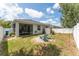 Backyard featuring a patio, shed, green grass, privacy fence and fire pit with Adirondack chairs at 13803 Chalk Hill Pl, Riverview, FL 33579