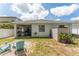 This backyard has an outdoor seating area, a small shed, a screened in porch and minimal grass at 13803 Chalk Hill Pl, Riverview, FL 33579