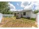 Fenced backyard featuring a small shed, lawn, and access to a screened lanai for outdoor enjoyment at 13803 Chalk Hill Pl, Riverview, FL 33579
