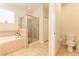 Bathroom with a walk-in shower, soaking tub, and neutral tile at 13803 Chalk Hill Pl, Riverview, FL 33579