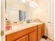 Bright bathroom features double sinks, wooden cabinets, a large mirror and plenty of counter space at 13803 Chalk Hill Pl, Riverview, FL 33579