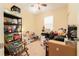 Bedroom with beige walls and carpet, ceiling fan and cluttered with boxes and totes at 13803 Chalk Hill Pl, Riverview, FL 33579
