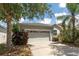 Exterior shot of home featuring a well kept lawn and a two car garage at 13803 Chalk Hill Pl, Riverview, FL 33579