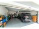 Spacious two-car garage with ample storage space and a black SUV parked inside at 13803 Chalk Hill Pl, Riverview, FL 33579