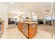 Bright kitchen with a center island featuring granite countertops and a decorative dishwasher at 13803 Chalk Hill Pl, Riverview, FL 33579