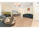 Spacious living room with comfortable seating, vaulted ceiling, and large windows at 13803 Chalk Hill Pl, Riverview, FL 33579