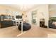 Office space featuring a large desk area and sliding doors to a patio area at 13803 Chalk Hill Pl, Riverview, FL 33579