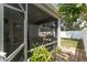 The screened porch has an outside view of the backyard, trees, and white fence at 13803 Chalk Hill Pl, Riverview, FL 33579