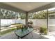 Covered, screened in patio with concrete floor, table and chairs, and views of the backyard at 13803 Chalk Hill Pl, Riverview, FL 33579