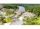 An aerial view of homes with well-kept landscaping near a serene lake and wooded area at 14134 Trouville Dr, Tampa, FL 33624