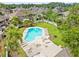 Expansive aerial view featuring a pool with lounge area and lush landscaping in backyard at 14134 Trouville Dr, Tampa, FL 33624