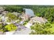 An aerial view of homes with well-kept landscaping near a serene lake and wooded area at 14134 Trouville Dr, Tampa, FL 33624