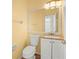 Well-lit half-bathroom with a vanity and a large mirror at 14134 Trouville Dr, Tampa, FL 33624