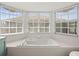 Bright bathroom featuring a large, square bathtub surrounded by windows with blinds at 14134 Trouville Dr, Tampa, FL 33624