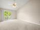Neutral bedroom featuring a ceiling fan and balcony access at 14134 Trouville Dr, Tampa, FL 33624