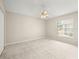 Spacious bedroom with neutral carpet, ceiling fan, and a window bringing in natural light at 14134 Trouville Dr, Tampa, FL 33624