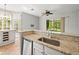 Open kitchen with granite countertops and stainless steel dishwasher at 14134 Trouville Dr, Tampa, FL 33624