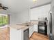 Well-equipped kitchen with granite countertops, stainless steel appliances and breakfast bar at 14134 Trouville Dr, Tampa, FL 33624