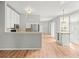 Bright kitchen with white cabinets, stainless steel appliances, granite countertops and hardwood floors at 14134 Trouville Dr, Tampa, FL 33624