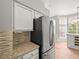 Gourmet kitchen features granite countertops and stainless steel refrigerator at 14134 Trouville Dr, Tampa, FL 33624