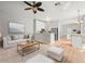 Open-concept living room and kitchen with modern decor and bright lighting at 14134 Trouville Dr, Tampa, FL 33624
