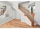 Attractive staircase featuring wood railing, carpeted steps, and hardwood floors at 14134 Trouville Dr, Tampa, FL 33624