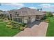 Expansive home showcasing its tile roof, three-car garage, and well-maintained lawn and landscaping at 14715 Fishhawk Preserve Dr, Lithia, FL 33547