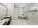 Bathroom featuring modern vanities, tub, and a glass enclosed shower at 14715 Fishhawk Preserve Dr, Lithia, FL 33547