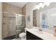 Modern bathroom featuring a tiled shower with glass door, toilet, and vanity with white countertop and cabinet at 14715 Fishhawk Preserve Dr, Lithia, FL 33547