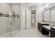 Bathroom featuring modern vanities, tub, and a glass enclosed shower at 14715 Fishhawk Preserve Dr, Lithia, FL 33547