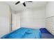 Bedroom featuring a plush blue bed, tufted headboard, and doorway to another room at 14715 Fishhawk Preserve Dr, Lithia, FL 33547