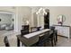 Dining room features a dark wood table, seating for six, with access to multiple rooms at 14715 Fishhawk Preserve Dr, Lithia, FL 33547