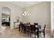 Formal dining room with a dark wood table, seating for six, and an elegant chandelier at 14715 Fishhawk Preserve Dr, Lithia, FL 33547
