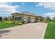 Spacious three-car garage complements the home’s stone facade and brick driveway at 14715 Fishhawk Preserve Dr, Lithia, FL 33547