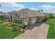 Beautiful luxury home with stone accents, tile roof, three car garage, paver driveway, and meticulously landscaped yard at 14715 Fishhawk Preserve Dr, Lithia, FL 33547
