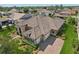Gorgeous house with tile roof, three car garage, beautiful stone facade, lush landscaping, and paver driveway at 14715 Fishhawk Preserve Dr, Lithia, FL 33547